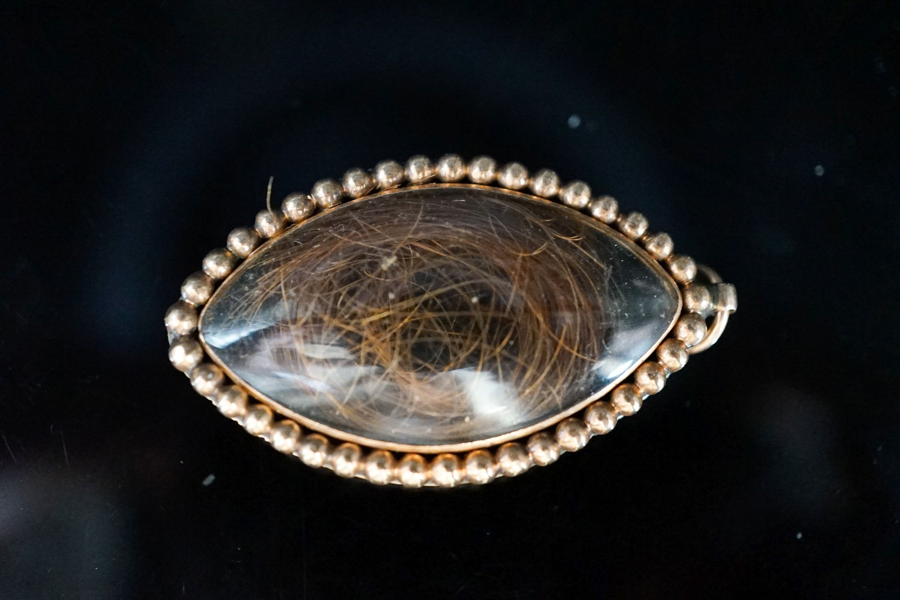 A Regency seed pearl set yellow metal locket and a mother of pearl cameo brooch